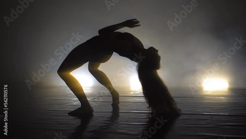 Sexy woman dancing modern ballet and contemporary choreography concept iin dark stydio with lights photo