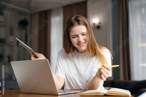 Female student at home online learning using a laptop computer. A woman is doing her homework on learning Spanish.