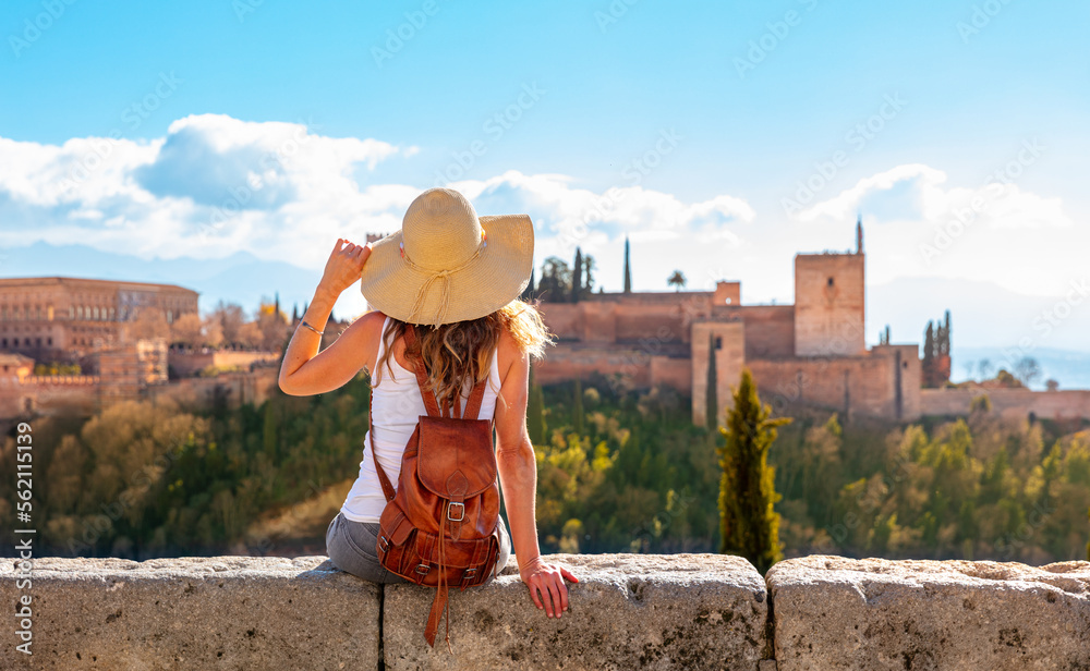 Tourism at Granada- Andalusia in Spain- Woman looking at Alhambra - obrazy, fototapety, plakaty 