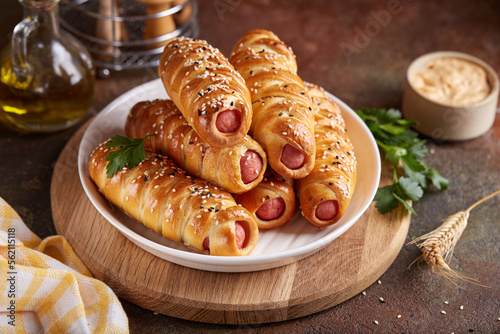Sausages baked in a yeast dough cover. Pigs in a blanket. Fast food. Savory snack. Delicious homemade appetizer.