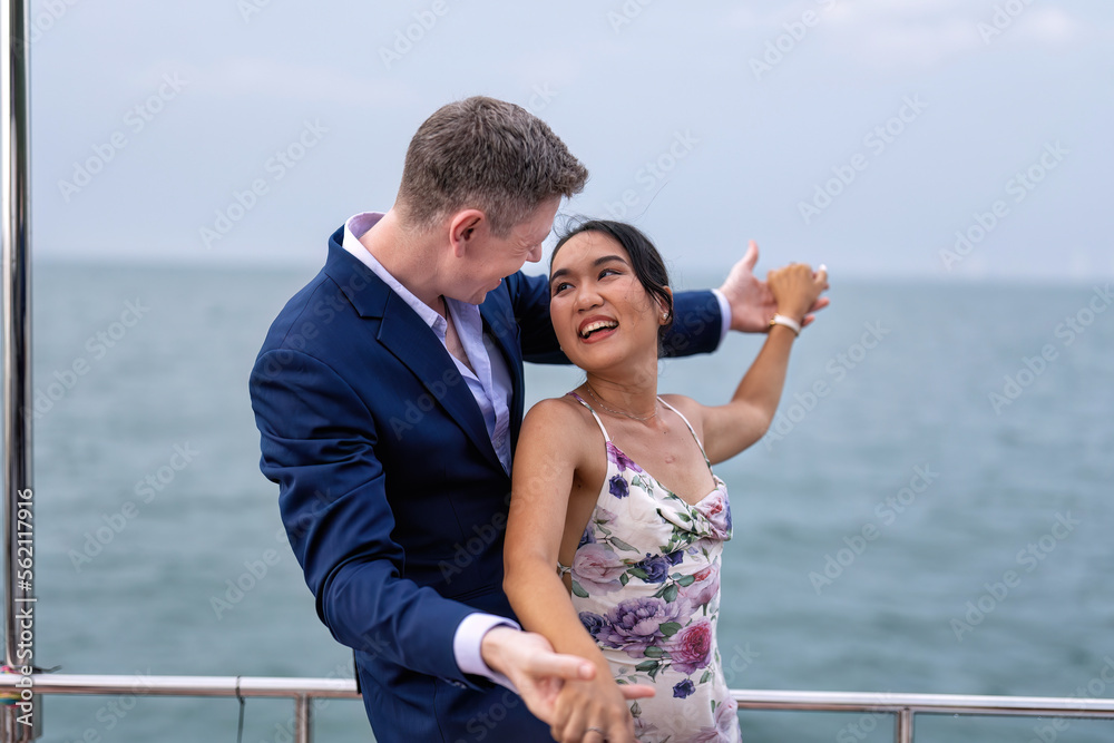 Obraz premium Romantic couple in love have fun sailing in the sea standing on yacht deck enjoy amazing view