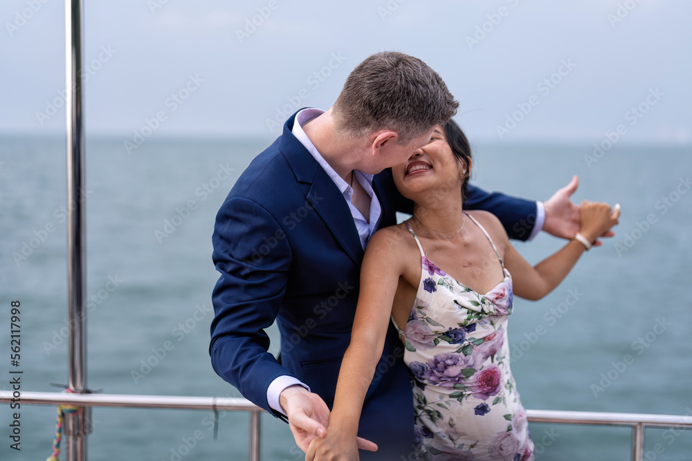 Romantic couple in love have fun sailing in the sea standing on yacht deck enjoy amazing view