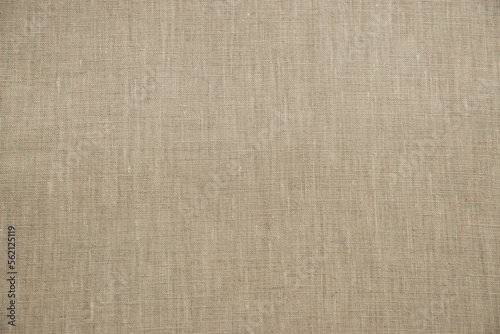 Natural color linen fabric texture closeup as textile background