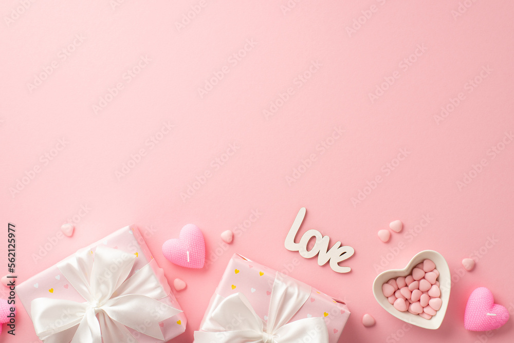 Valentine's Day concept. Top view photo of present boxes with white ribbon bows heart shaped saucer with sprinkles candles and inscription love on isolated pastel pink background with empty space