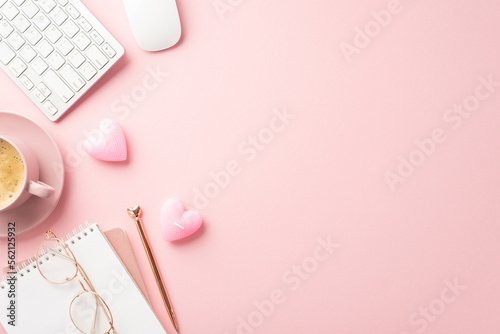 St Valentine's Day concept. Top view photo of notepad pen keyboard computer mouse glasses heart shaped candles and cup of coffee on saucer on isolated pastel pink background with copyspace