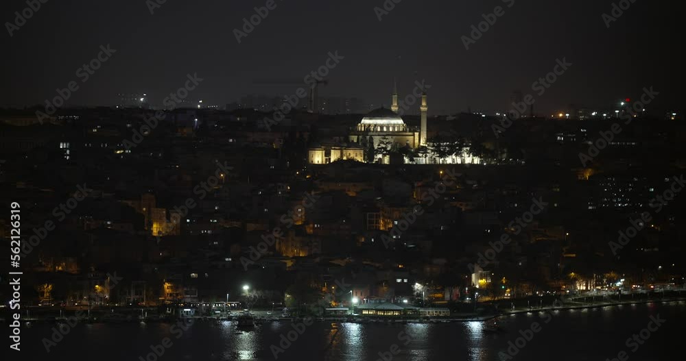 A night view of a lit Turkish Mosque, in the middle of a quiet neighborhood. some part of the sea is visible and few cars are moving in the seafront boulevard. A DCI 4K video, Istanbul, Turkey. A night view of a lit Turkish Mosque, in the middle of a quiet neighborhood. some part of the sea is visible and few cars are moving in the seafront boulevard. A DCI 4K video, Istanbul, Turkey.