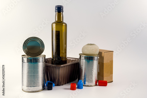 collection of household trash garbage for recycling aluminium cans glass bottle cardboard and plastics isolated on a white background