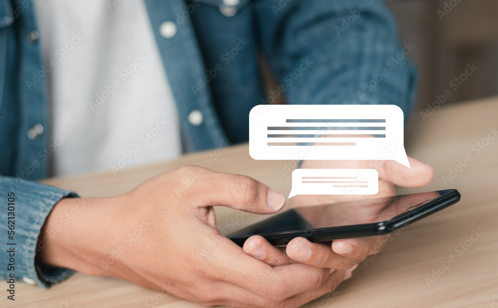 Man using smartphone to work from home. Conversation in the chat box icon that appears. social media concept. Man using smartphone to work from home. Conversation in the chat box icon that appears. social media concept.
