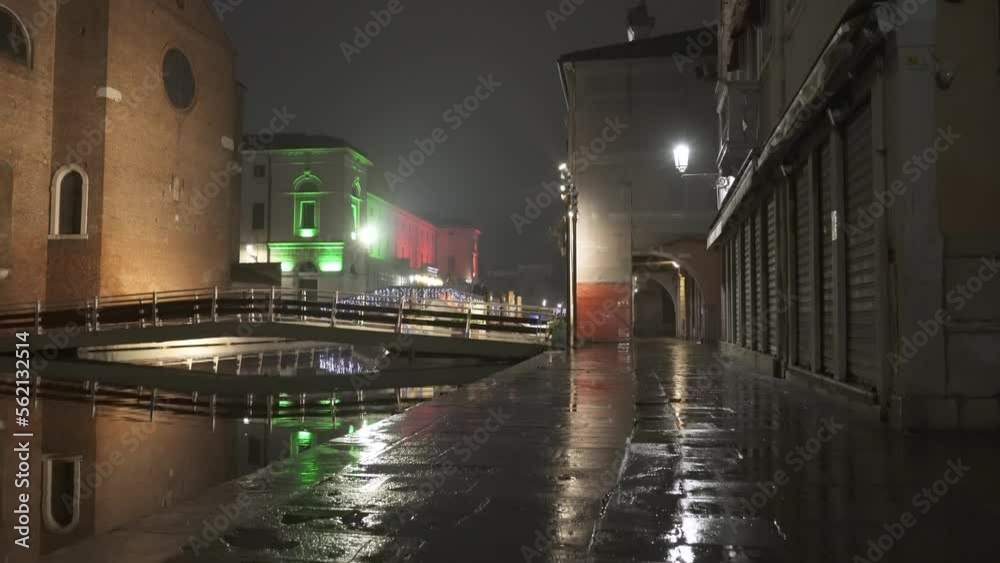 Beautiful ancient city Chioggia, located in the Venice lagoon. The road is illuminated by lighthouses and together with the water of the canal it reflects these on its surface. Beautiful ancient city Chioggia, located in the Venice lagoon. The road is illuminated by lighthouses and together with the water of the canal it reflects these on its surface.
