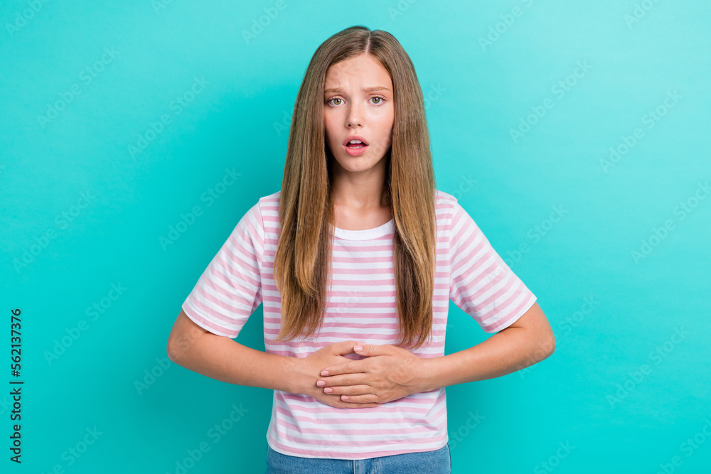Photo of unhappy upset lady wear striped t-shirt arms stomach having pain isolated turquoise color background Photo of unhappy upset lady wear striped t-shirt arms stomach having pain isolated turquoise color background