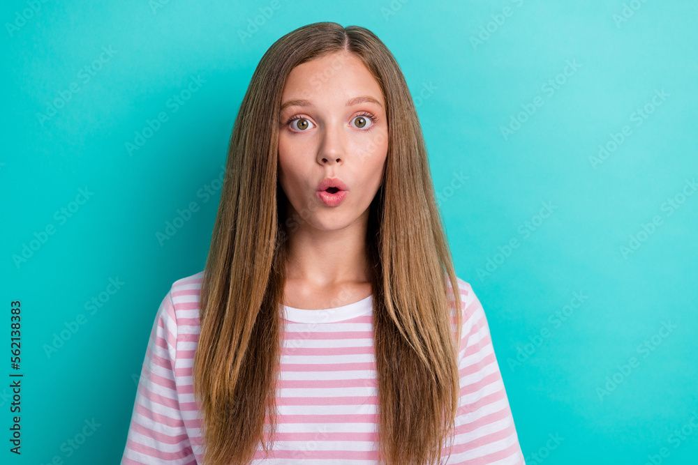 Photo of shocked speechless young girl pouted lips open mouth cant believe isolated on teal background Photo of shocked speechless young girl pouted lips open mouth cant believe isolated on teal background