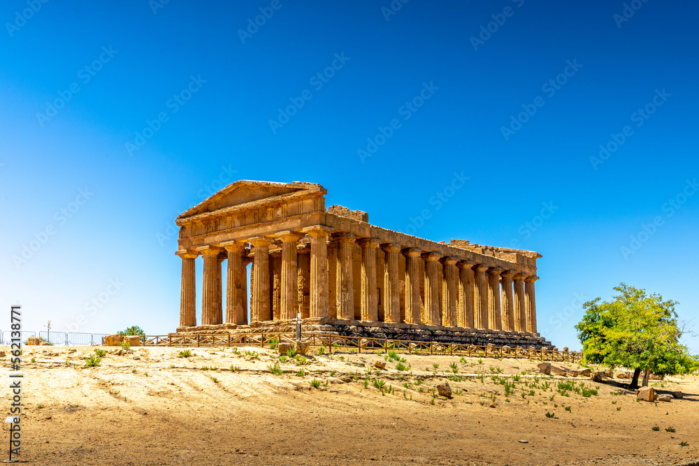 Agrigento, Sicily, Italy - July 12, 2020: Greek ruins of Concordia Temple in the Valley of Temples near Agrigento in Sicily - obrazy, fototapety, plakaty 