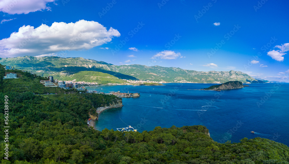 Panorama of bird's eye view of towns of Budva and Becici with hotels and beaches near Adriatic Sea against the backdrop of the Montenegrin Mountains