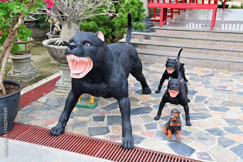Fotografie, Obraz Statues of black American pit bull terriers roaring in the park inside a Thai Chinese temple at Thailand