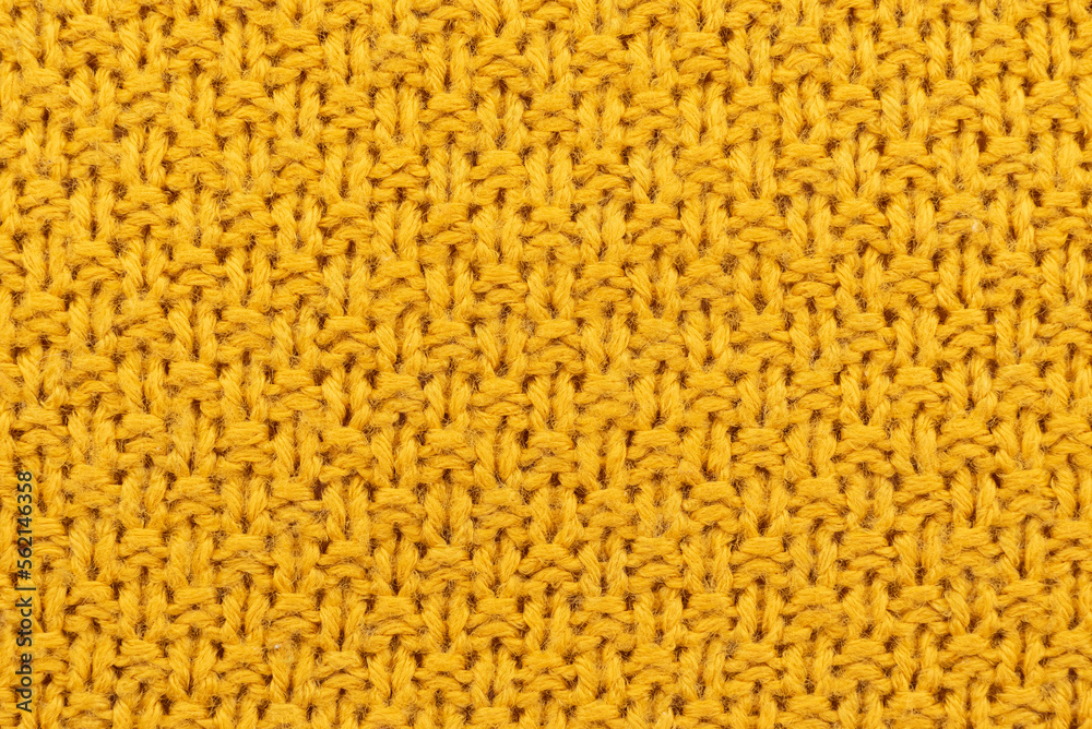 Fototapeta premium Texture or background of knitted yellow material. Knitting. Hobby