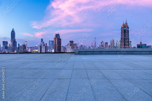 Empty square floor and city skyline with modern buildings at sunset in Shanghai, China.