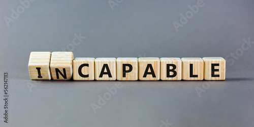 Capable or incapable symbol. Concept words Capable or Incapable on wooden cubes. Beautiful grey table grey background. Business capable or incapable concept. Copy space. photo