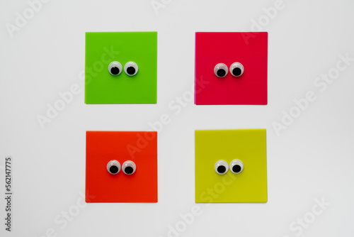 pairs of googly eyes on colored card isolated on a white background