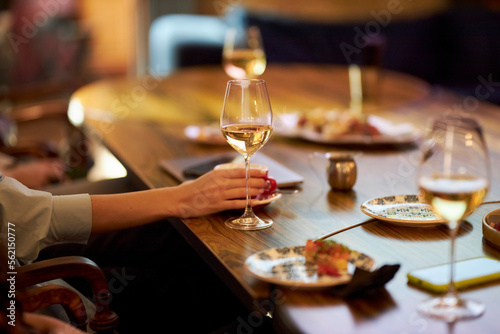 The girl holds a glass in her hand. Champagne. A party 