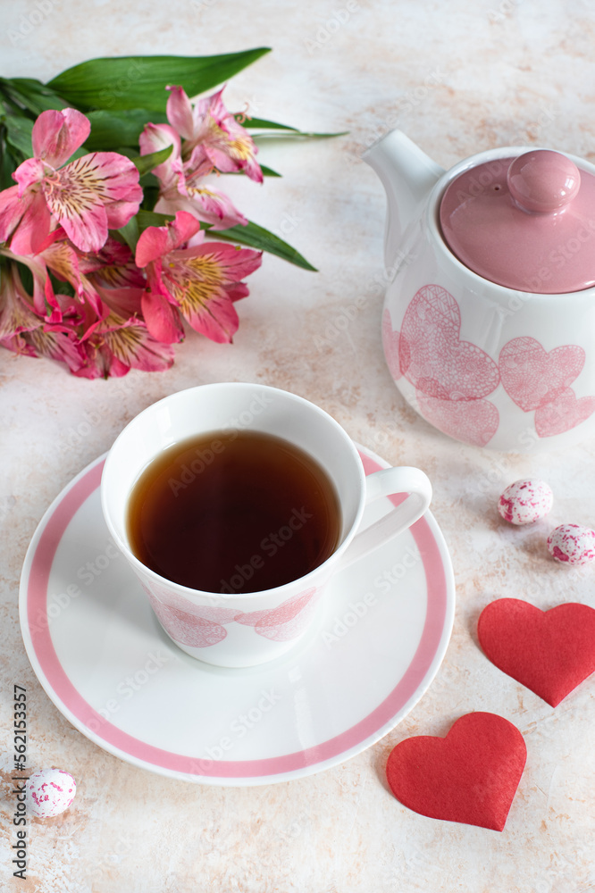 cup with tea, teapot and rose flowers on the table cup with tea, teapot and rose flowers on the table
