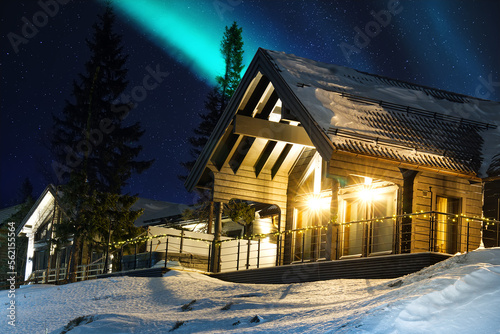 ski resort at night. sweden ski resort are at night. wooden log cottages in mountains with stars on sky.