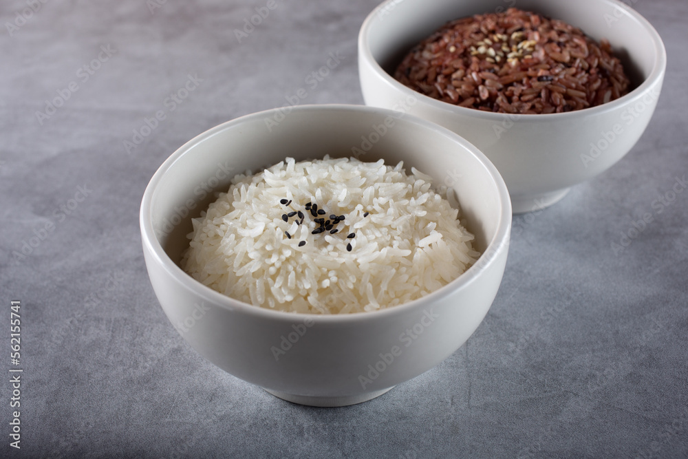 A view of bowls of rice, featuring steamed white rice and colored brown rice. A view of bowls of rice, featuring steamed white rice and colored brown rice.
