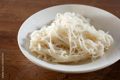 A view of a plate of cooked rice noodles.