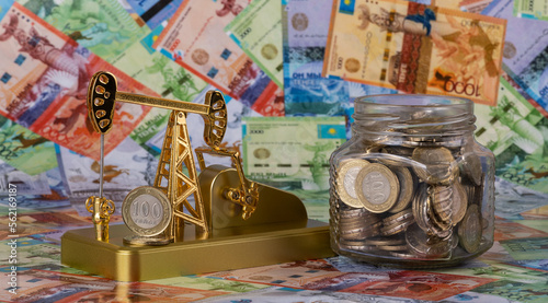 Oil pump, Kazakh coins against the background of Kazakh banknotes (tenge) © Max Zolotukhin