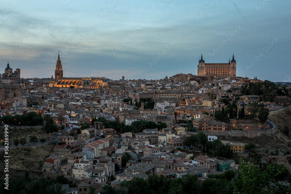General view of Toledo, Spain, from viewpoint of the valley during the sunset with the cathedral and the fortress on the top of skyline