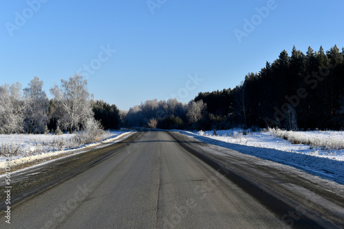 A high-speed road in a snow-covered field. Snowy road in winter.