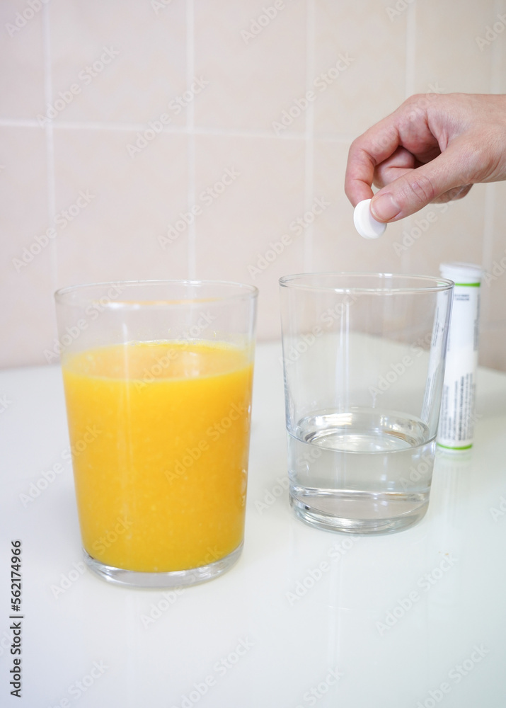 an orange juice and a pills in water. cold and illness immunity an orange juice and a pills in water. cold and illness immunity