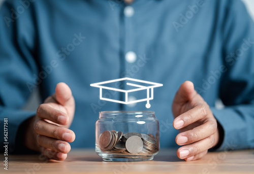 Businessman saving money coins with jar for education concept. Graduation hat on jar saving money. study, learning, school, university, diploma. Save money for prepare in the future.