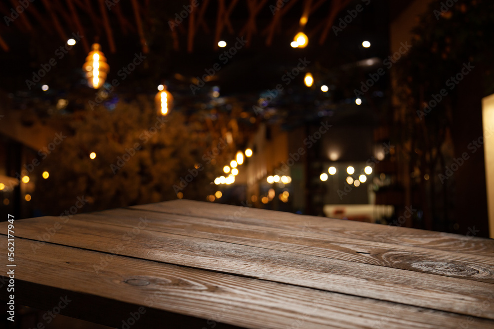 empty wooden brown table on blurred light gold bokeh cafe restaurant bar, place for your products on the table. Abstract background