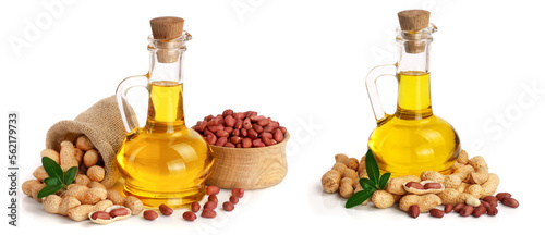peanut oil in a glass bottle with peanuts in bowl photo