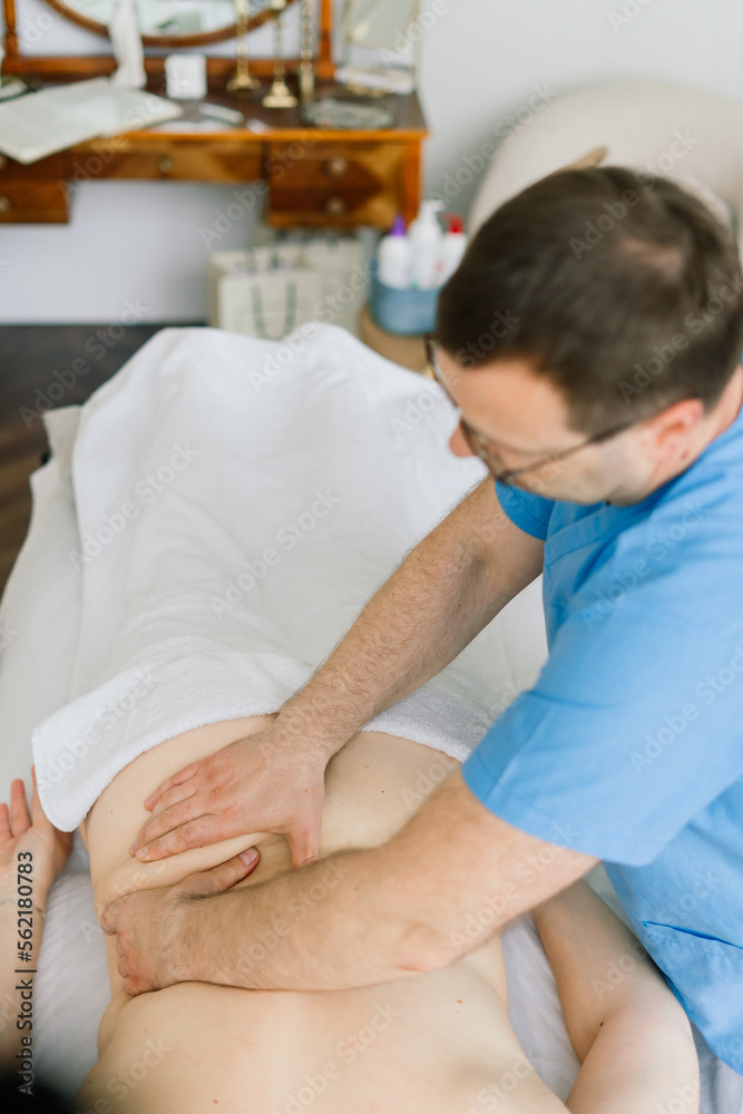 Young fat woman getting massage treatment in day spa cabinet. Young fat woman getting massage treatment in day spa cabinet.