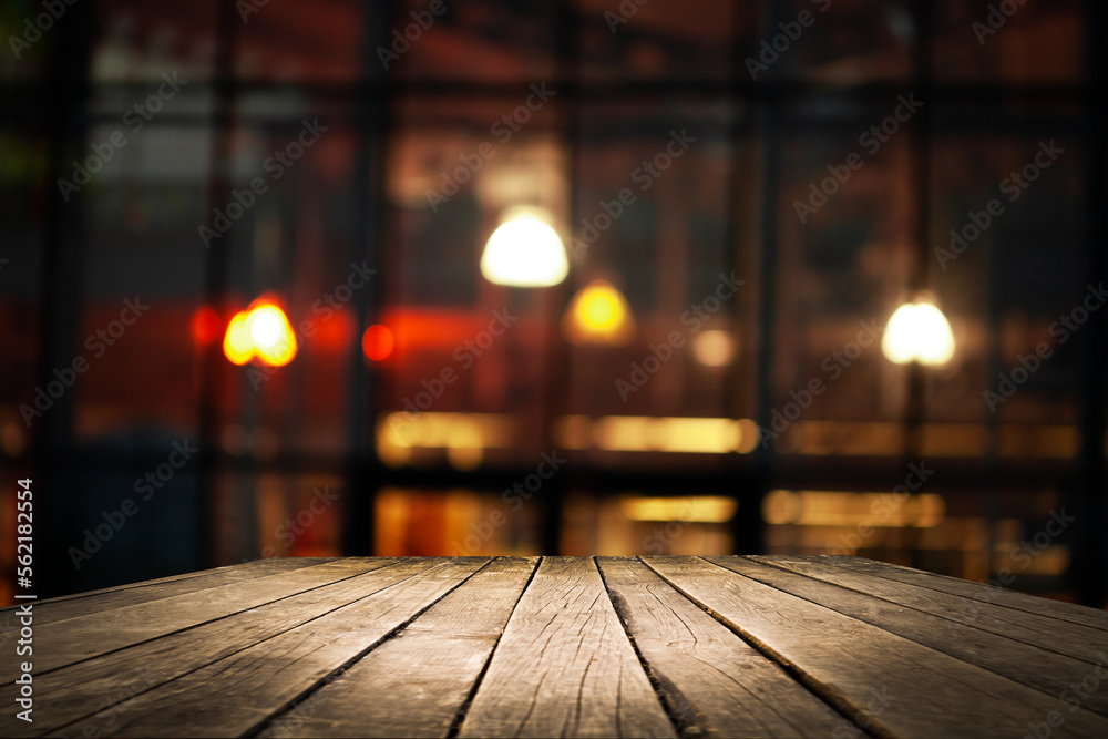 Empty workplace, table on the background of blurred cafe lights Empty workplace, table on the background of blurred cafe lights