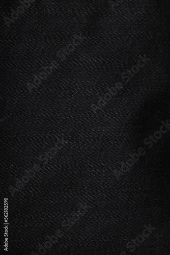 the texture of denim is gray with a side double seam. thread stitches on the background of denim textiles. place to copy. Abstract background and texture for design.