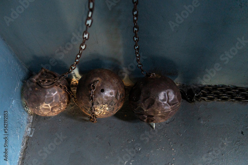 Old ball and chains against a blue wall in a jail photo