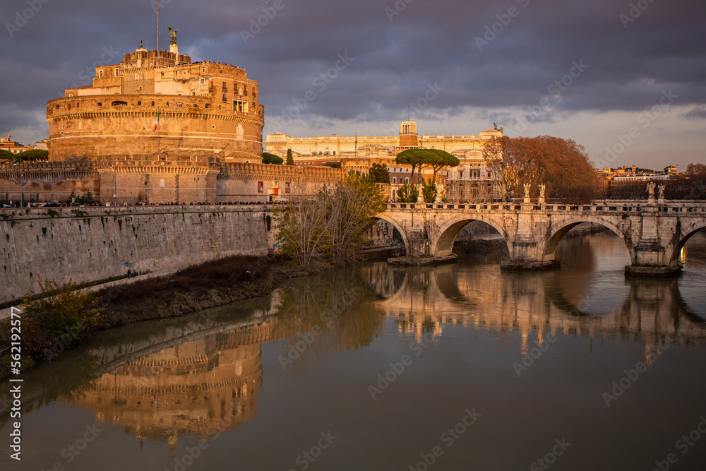 Bridge over the Tiber river in Rome with a view in the distance of the Castle of Saint Angel
