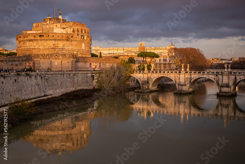 Bridge over the Tiber river in Rome with a view in the distance of the Castle of Saint Angel