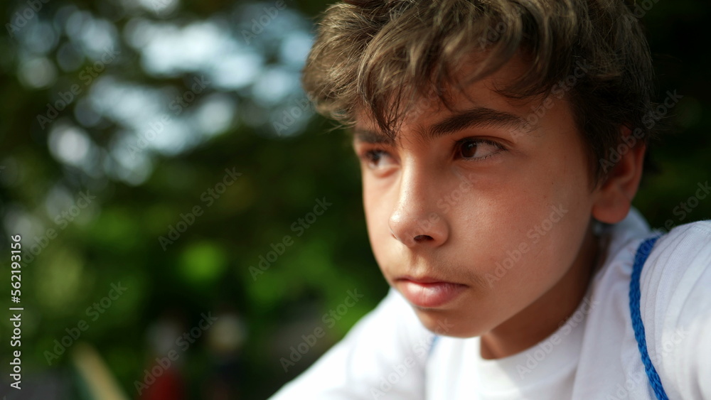Pensive handsome young boy portrait face outside Pensive handsome young boy portrait face outside
