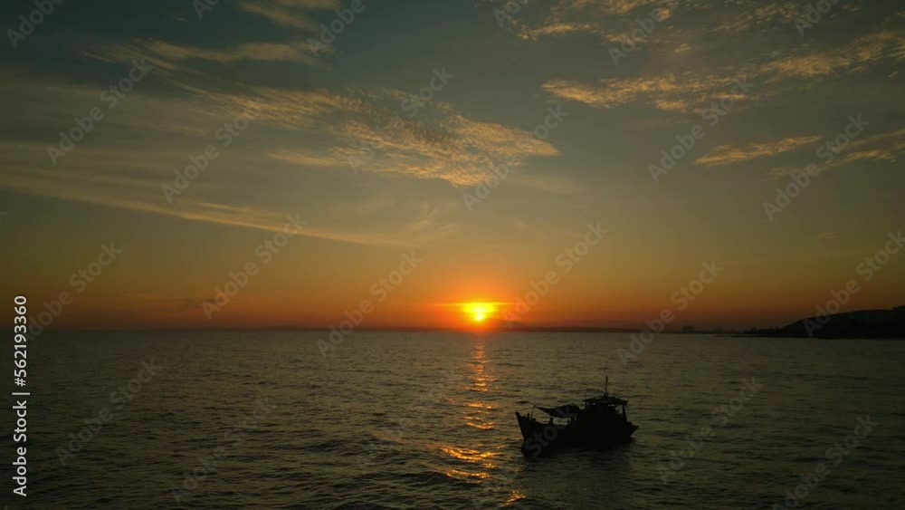 Beautiful calm sunset with only one yacht on the sea. Shooting from a drone, flying along the sea against the background of a sunset and a fishing boat. Fishermen in the sea are fishing at sunset. 4K Beautiful calm sunset with only one yacht on the sea. Shooting from a drone, flying along the sea against the background of a sunset and a fishing boat. Fishermen in the sea are fishing at sunset. 4K
