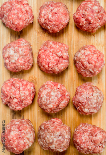 Raw meat meatballs on the Board .
