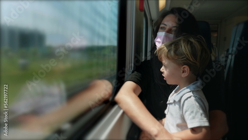 Mother and child riding train wearing covid-19 face mask4 © Marco