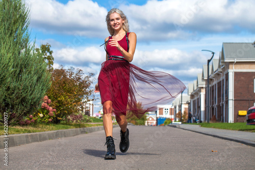 Young beautiful girl walking on the street photo