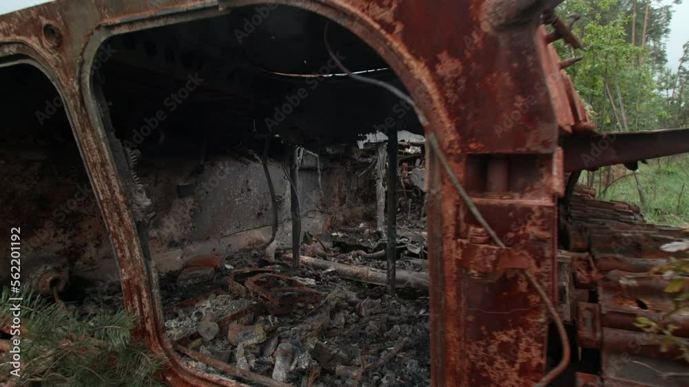 March, 2022. Irpin, Ukraine. Burnt and broken tank remains in suburbs of occupied town. Inside Russian military vehicle in green forest by the road. High quality 4k footage March, 2022. Irpin, Ukraine. Burnt and broken tank remains in suburbs of occupied town. Inside Russian military vehicle in green forest by the road. High quality 4k footage
