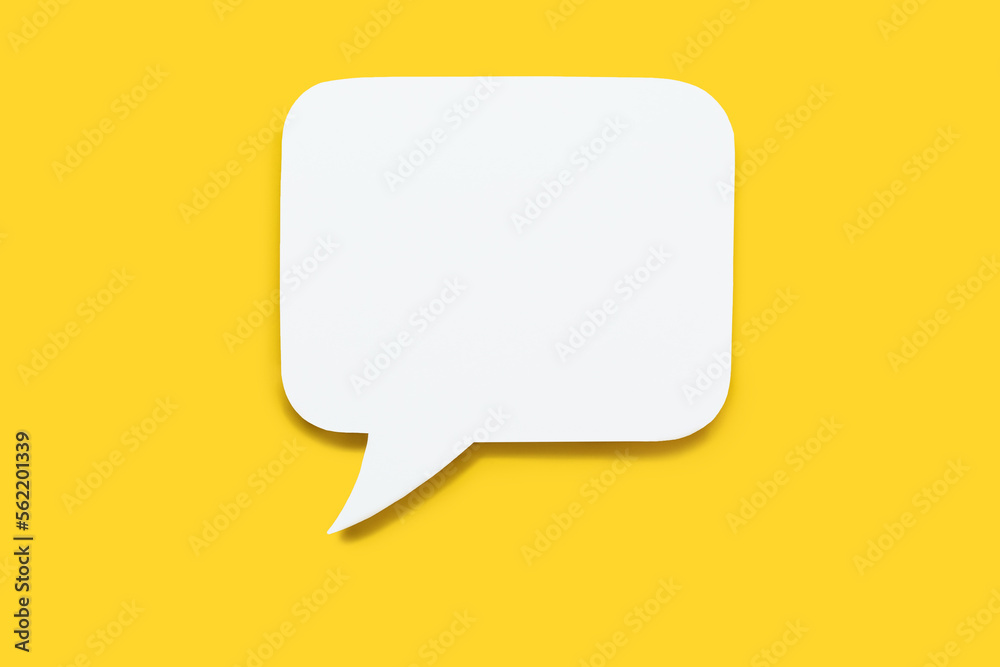 Paper speech bubble in the shape of a rectangle on a yellow background. Flat white chat icon in the form of an empty speech bubble. Free space for text or image. Internet communication concept - obrazy, fototapety, plakaty 