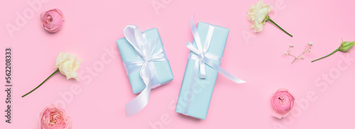 Beautiful flowers and gifts on pink background, top view