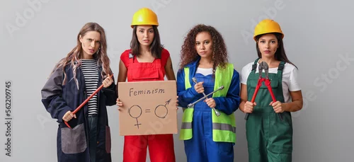 Obraz Female workers on light background. Concept of feminism