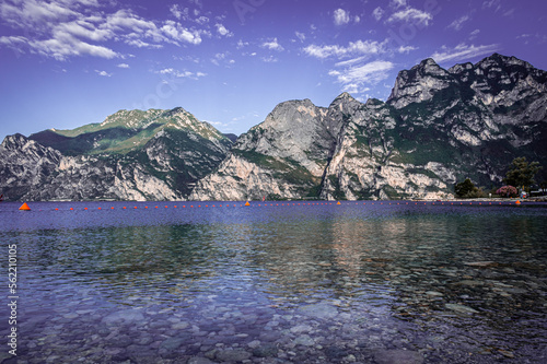 Stone beach in Italy without people  North shore of the lake Lago di Garda near Torbole  Nago-Torbole  morning sunny day  favorite holiday destination